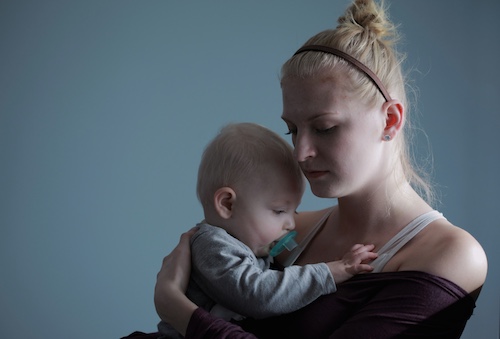 Woman Holding Baby With Postpartum Depression