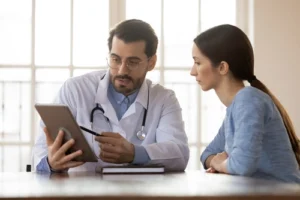 A healthcare professional explaining the placebo controlled study on the effectiveness of treatment medications for patients with bipolar disorder and alcohol dependence.