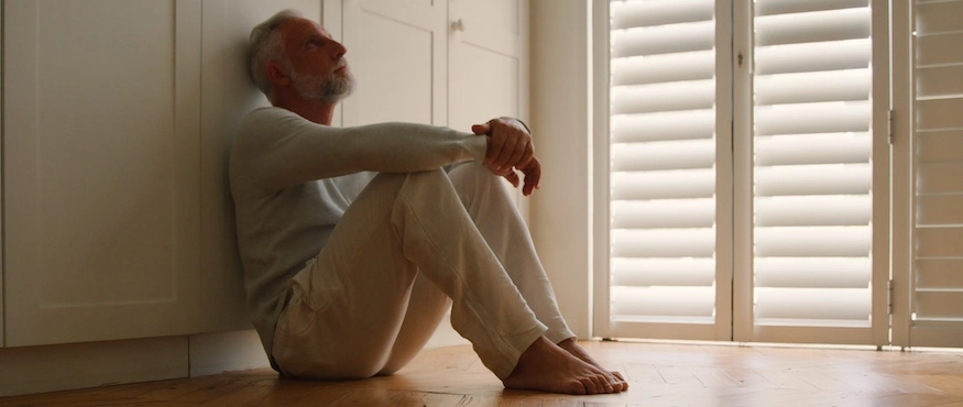 A depressed person is sitting down and desperately needs to be put into a raleigh drug rehab center.