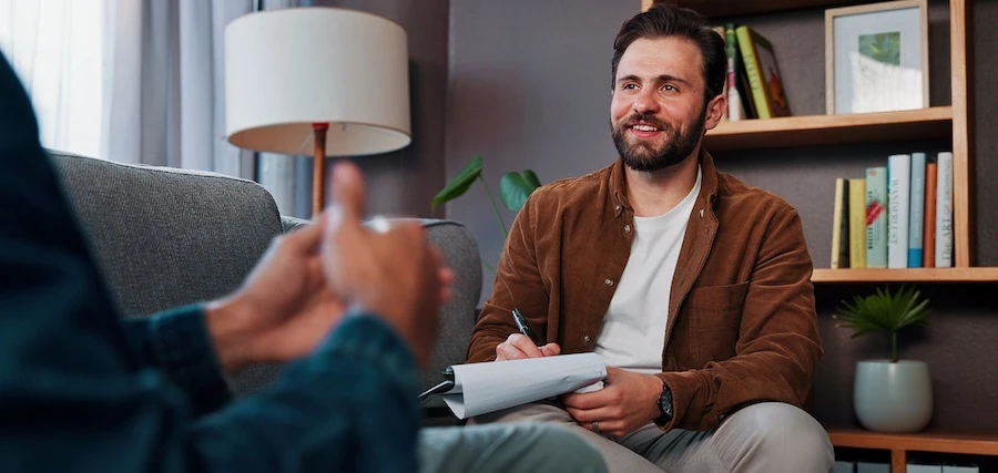 A Raleigh professional is talking with a client at a drug rehab center.