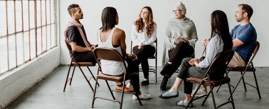 A group is chatting with one another at a Raleigh alcohol rehab center.
