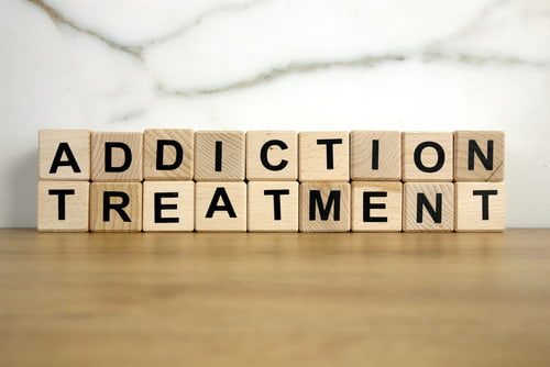 Wooden blocks spell addiction treatment.